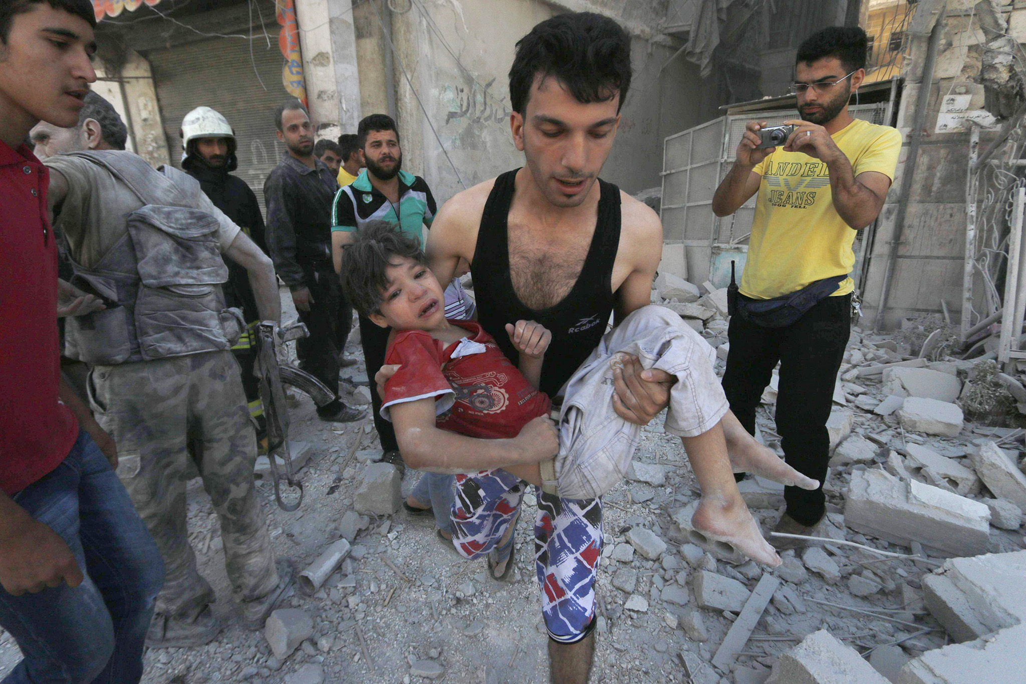 Hosam Katan/Reuters A man carries an injured child after what activists said were barrel bombs were dropped by forces of Syria’s President Bashar Al-Assad in Aleppo’s al-Saliheen district, on Friday. MPC Journal, Hakim Khatib
