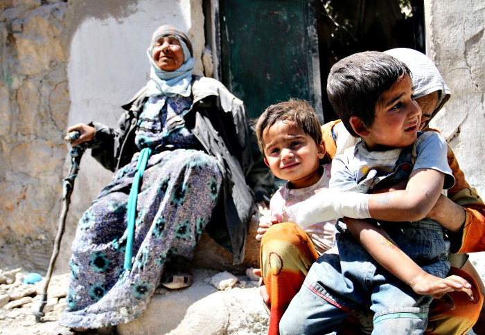 A Syrian woman comforts her children after their house in the northern Syrian city of Aleppo was bombed by forces loyal to the Syrian regime. MPC Journal, Zein Al-Rifei/AFP