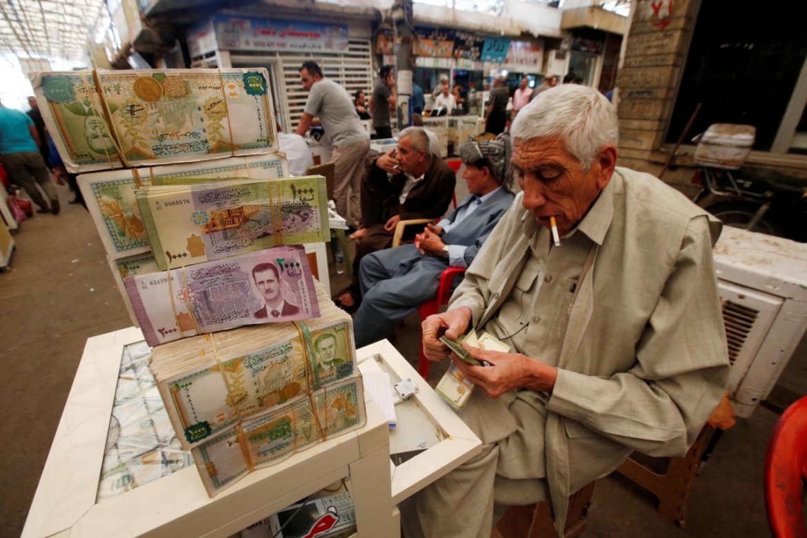 A man counts money at Stock Exchange in Erbil