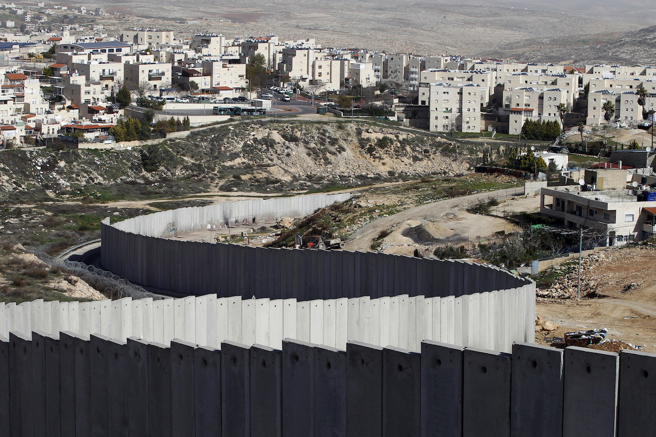 A section of the controversial Israeli barrier is seen between the Shuafat refugee camp (right) in the West Bank near Jerusalem and Pisgat Zeev (rear), in an area of Israel annexed to Jerusalem after capturing it in the 1967 Middle East war, Jan. 27, 2012. PHOTO: REUTERS/BAZ RATNER